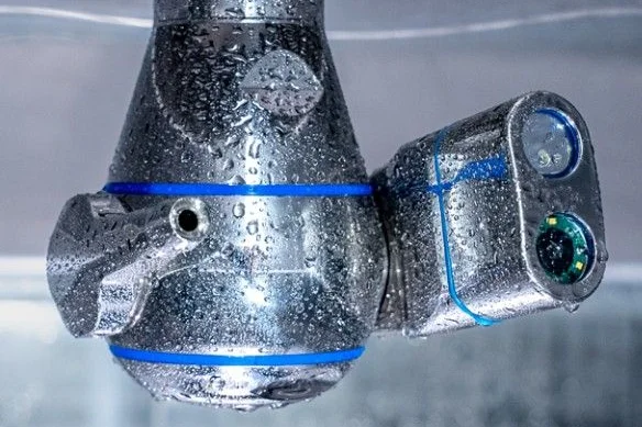 Image of a component being cleaned underwater