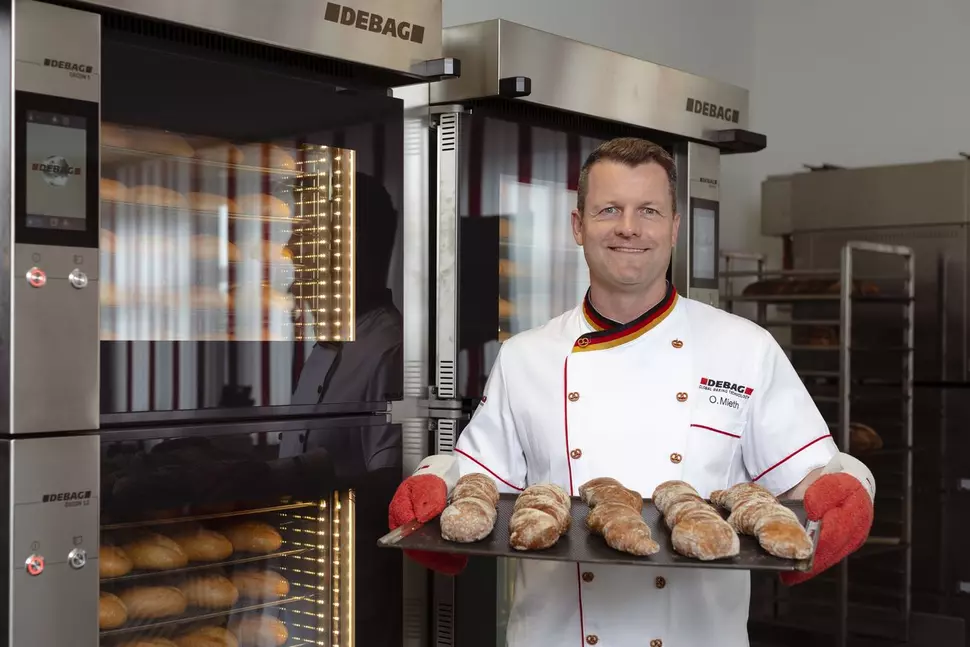 Master baker in front of a DECON shop oven from DEBAG